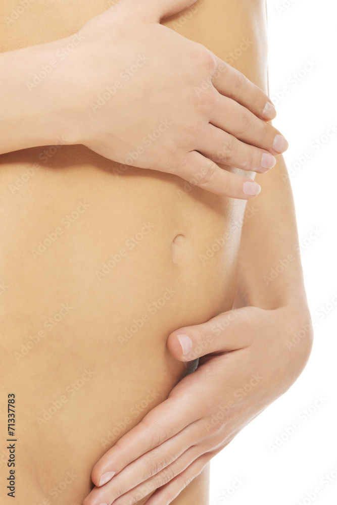 Attractive woman with her hands on her belly Attractive woman with her hands on her belly
