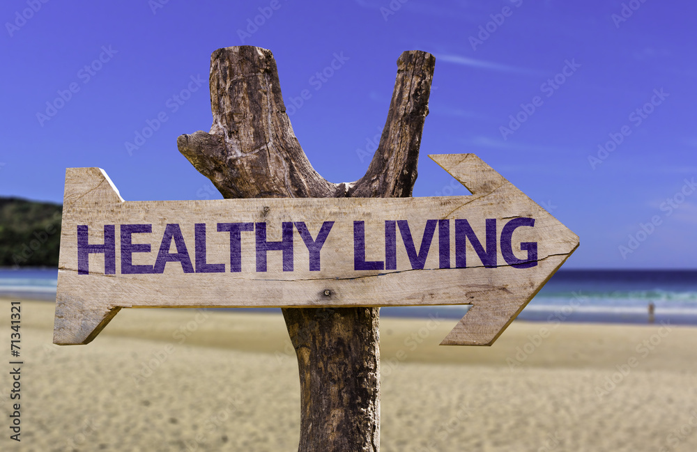 Healthy Living wooden sign with a beach on background