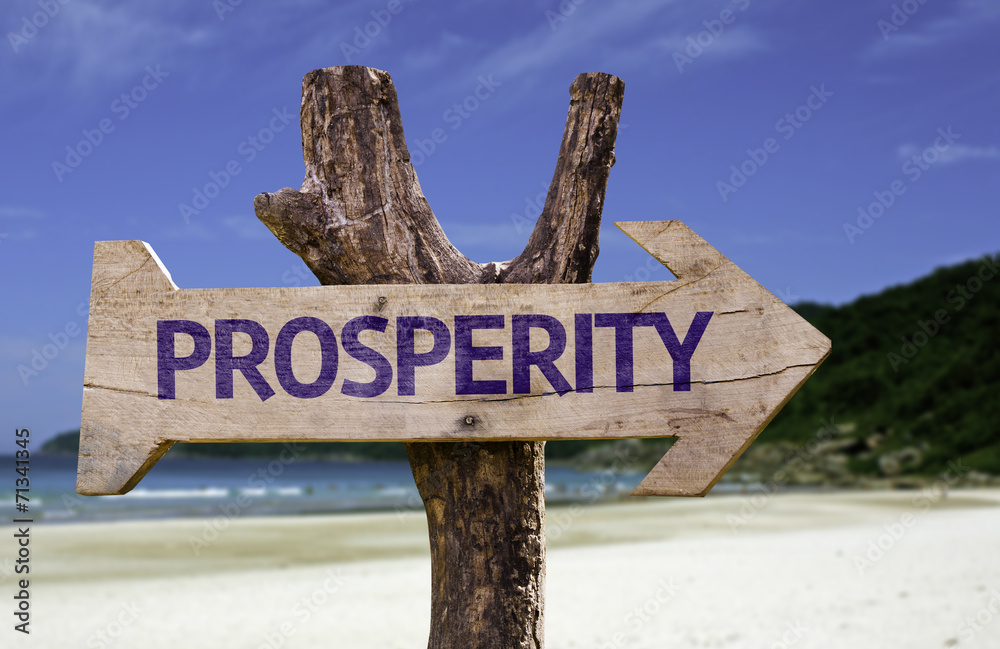 Prosperity wooden sign with a beach on background