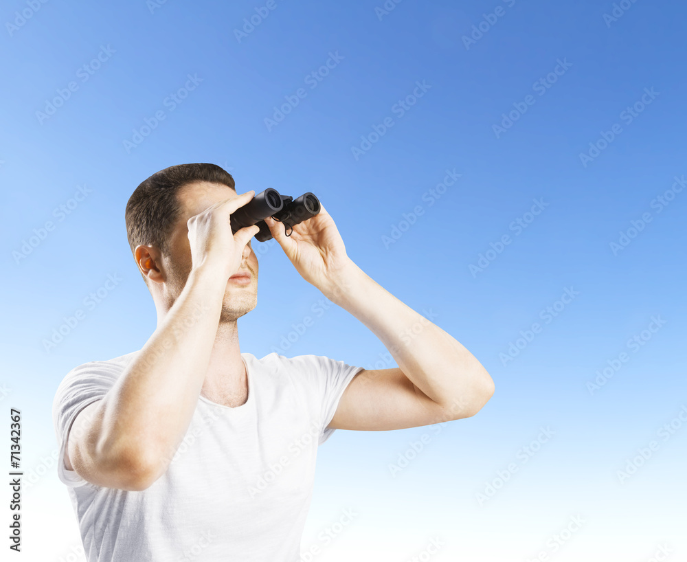 man looking through binoculars