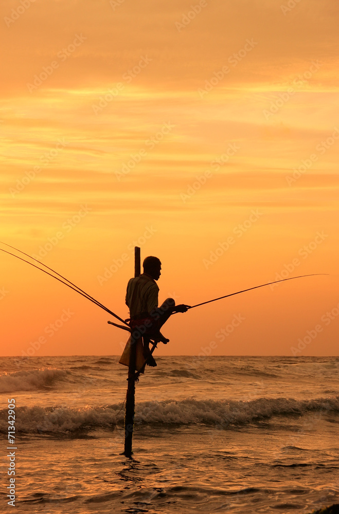 Silhouette of a stick fisherman at sunset, Unawatuna, Sri Lanka