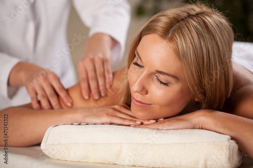 Beautiful woman having arm massage