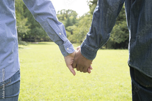 Men and women holding hands in the park