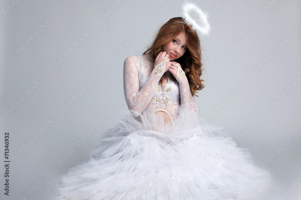 Image of pretty red-haired girl dressed as angel Image of pretty red-haired girl dressed as angel