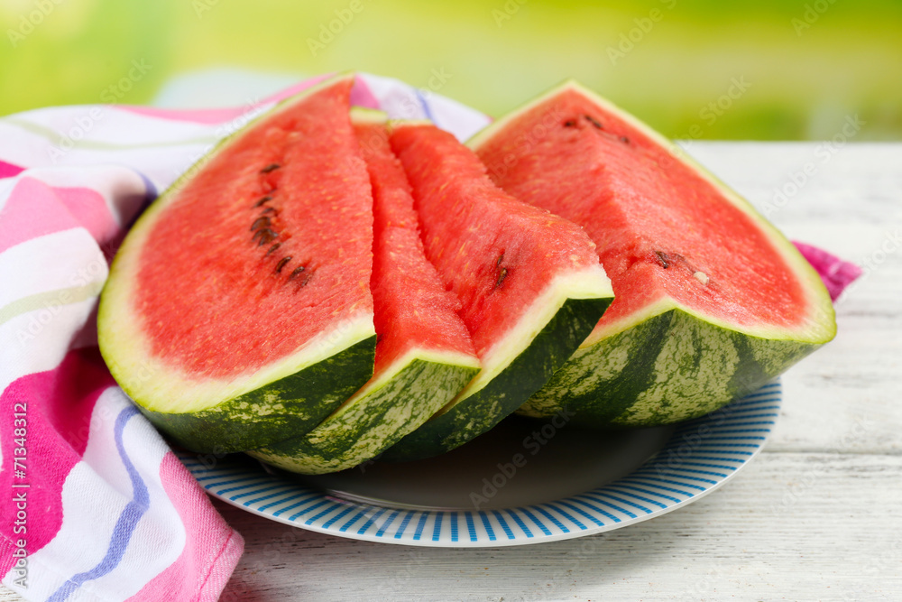 Fresh slice of watermelon on table outdoors, close up Fresh slice of watermelon on table outdoors, close up