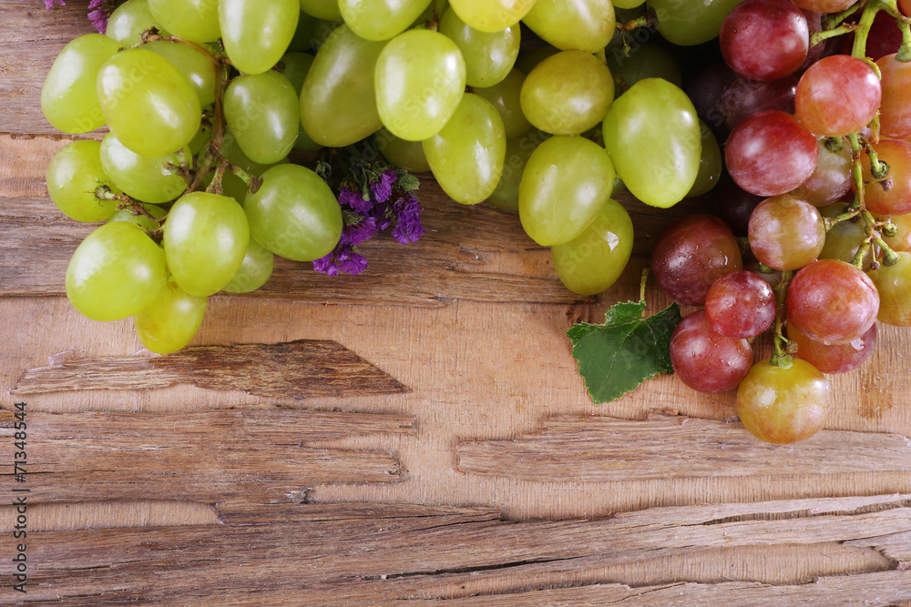 Bunches of grapes on wooden background Bunches of grapes on wooden background
