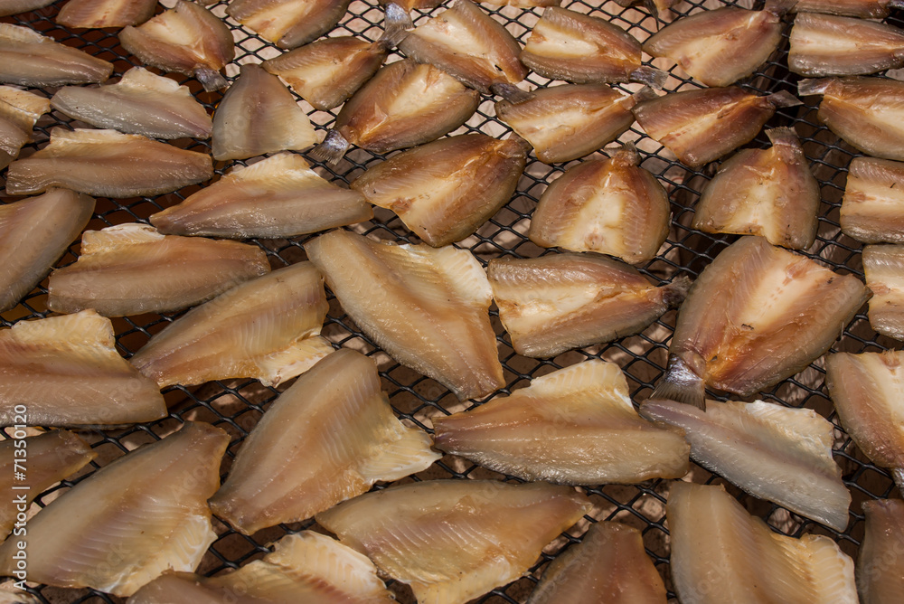 Dried fish slices on the grid.