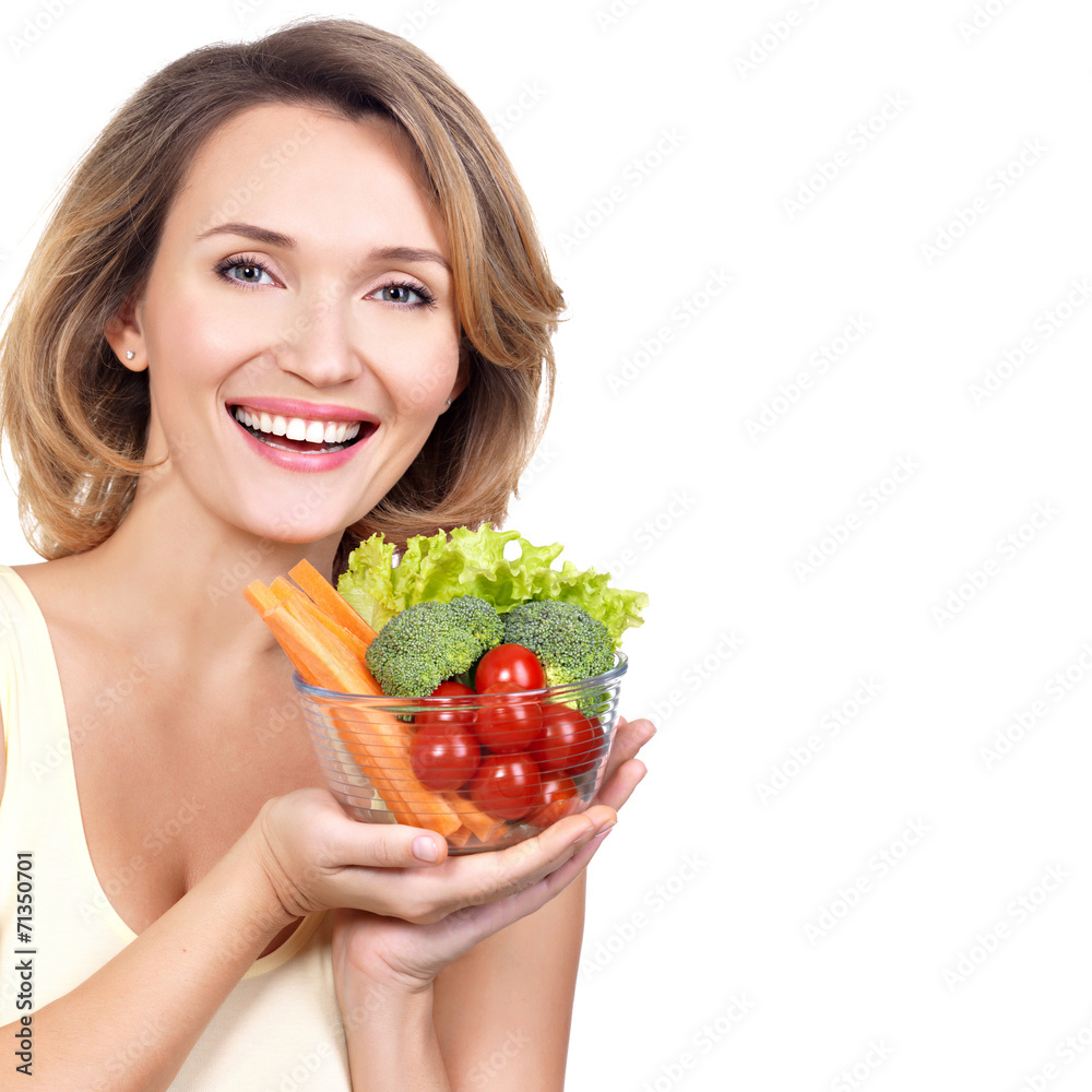 Portrait of a young smiling woman with a plate of vegetables. Portrait of a young smiling woman with a plate of vegetables.