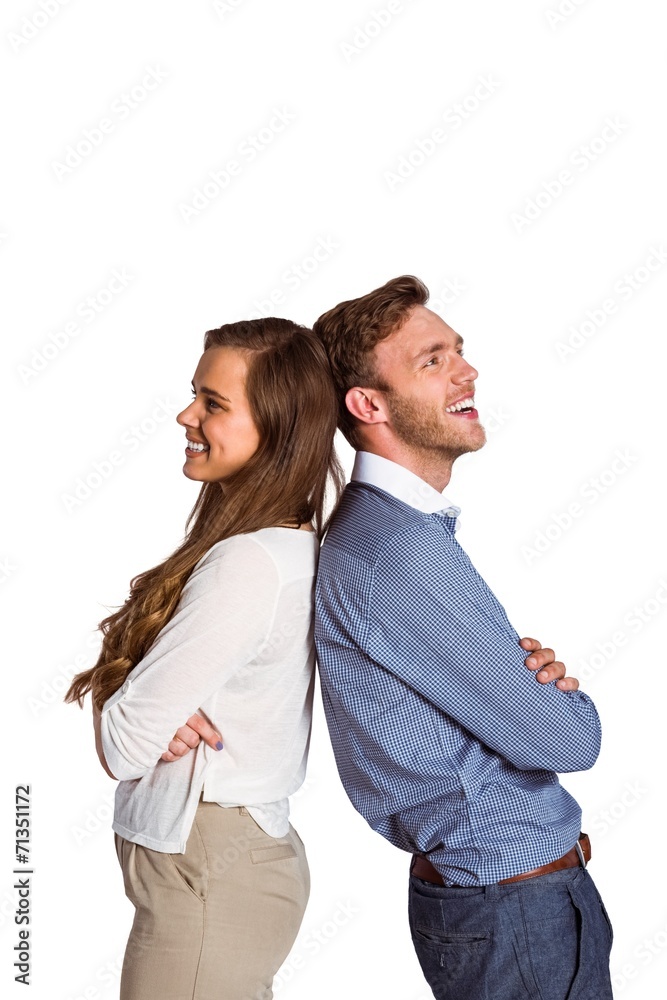 Happy young couple standing back to back Happy young couple standing back to back