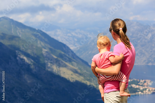 mother with little daughter looking at mountains