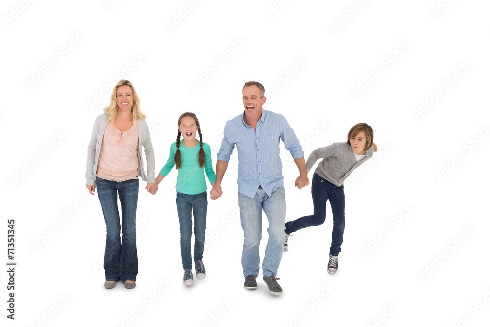 Happy family of four walking hand in hand