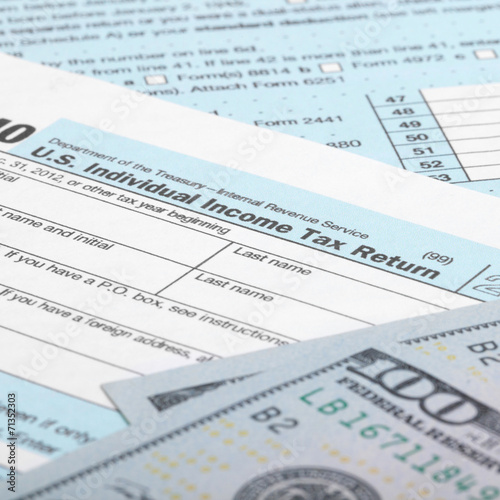 USA Tax Form 1040 with USA dollars bills - 1 to 1 ratio