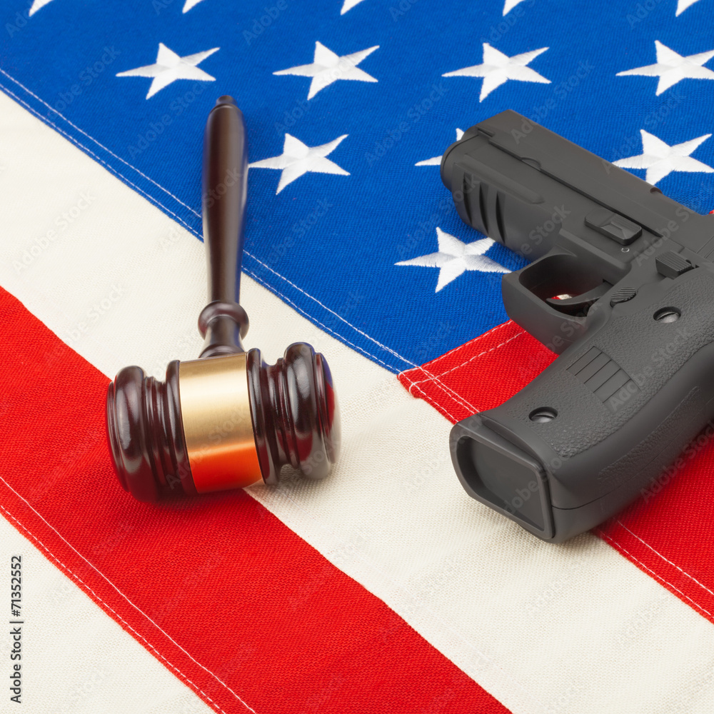 Gun and judge gavel over USA flag - studio shoot - 1 to 1 ratio Gun and judge gavel over USA flag - studio shoot - 1 to 1 ratio