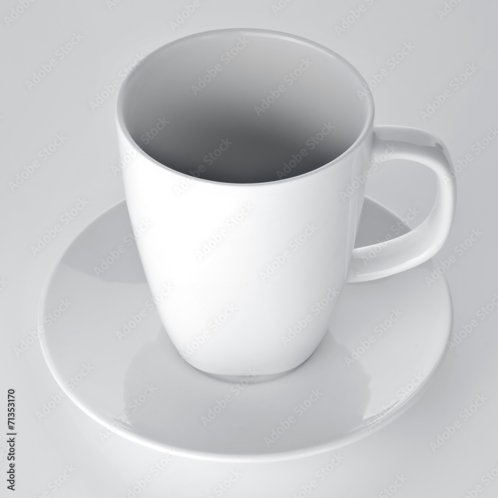 White cup with seucer isolated on gray background White cup with seucer isolated on gray background