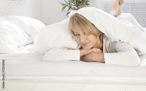 beautiful girl in the morning in bed smiling