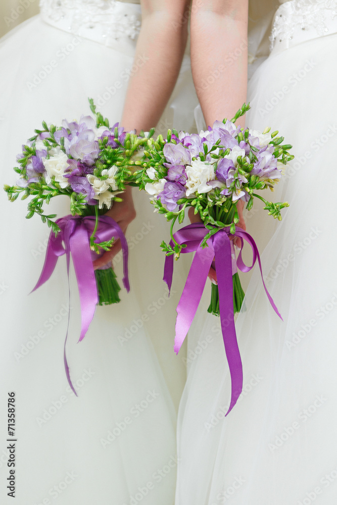 Wedding bunch of flowers in hands of the bride