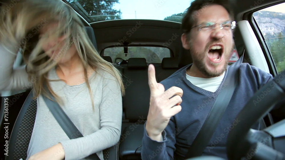 Couple having fun dancing in car