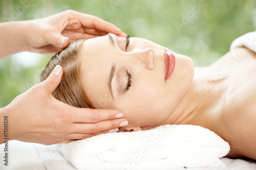 Woman relaxing at a spa having a facial