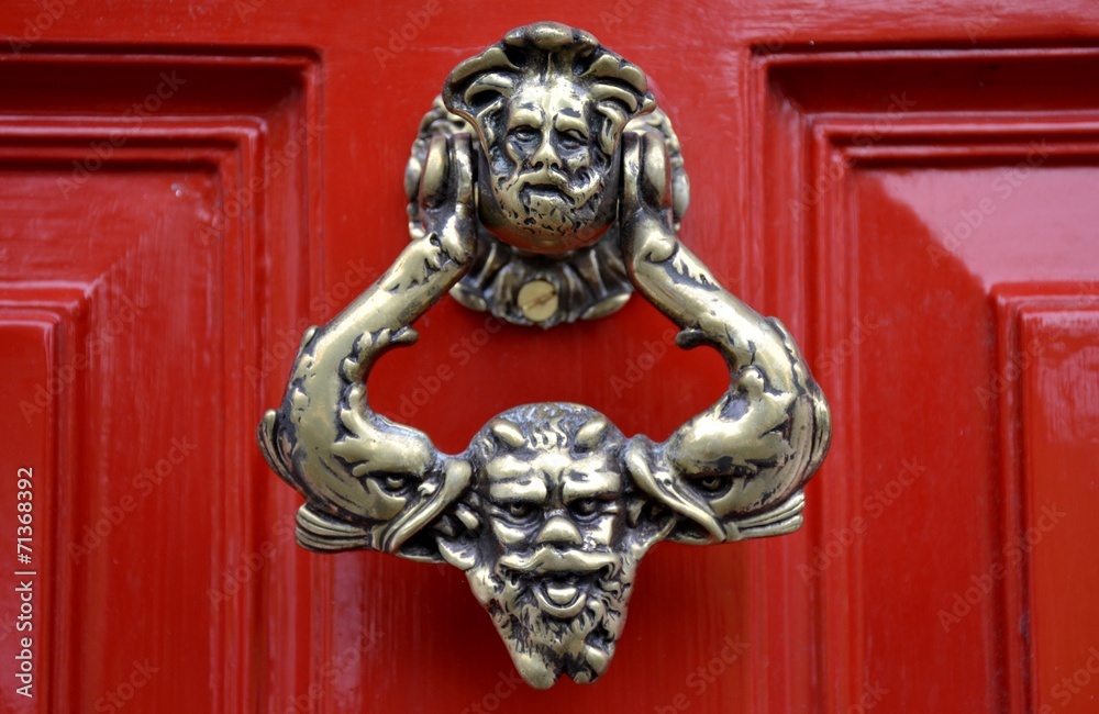Old door knocker and red background