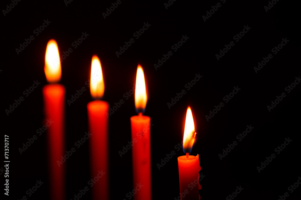 four candles on black background four candles on black background