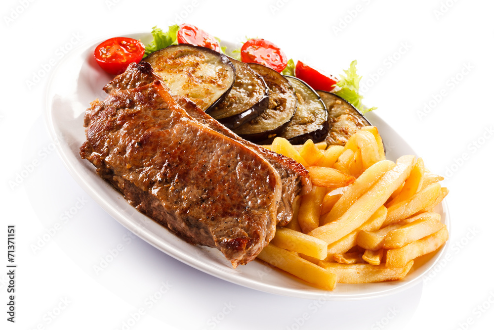 Grilled steak, French fries and vegetables Grilled steak, French fries and vegetables
