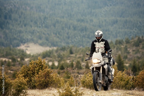 Man Driving a Motorcycle in Nature