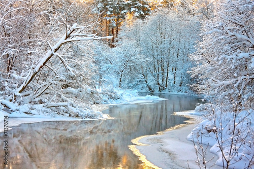 winter landscape with a river at sunset