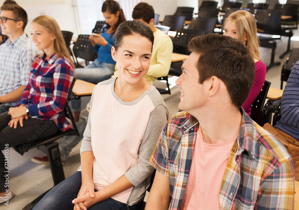 group of smiling students in lecture hall