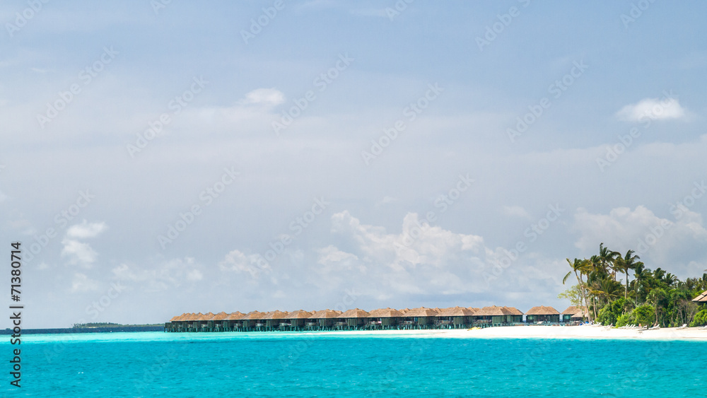 View of the coast of irufushi island with a bungalows, maldives