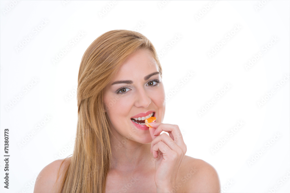 Smiley girl bites citrus fruit – Happy woman eats a portion of Smiley girl bites citrus fruit – Happy woman eats a portion of