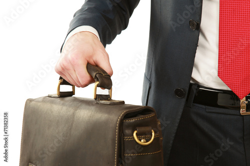 A unknown bussinesman holding case.