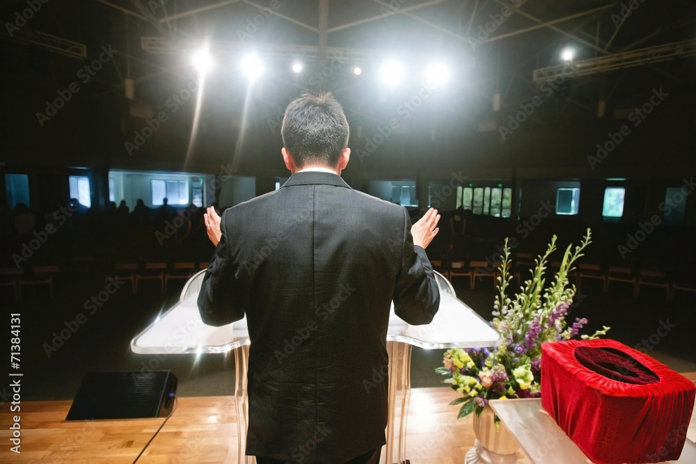 Fototapeta premium Pastor praying for congregation