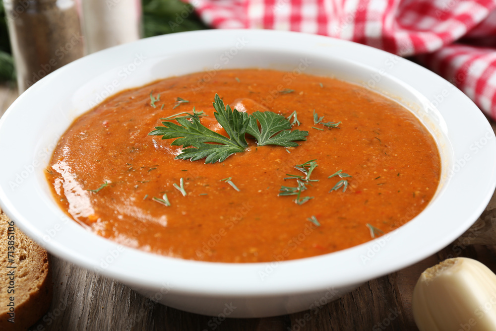 Delicious lentil cream-soup on table close-up