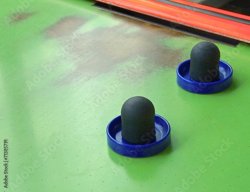 Air hockey table closeup with paddle at amusement arcade photo