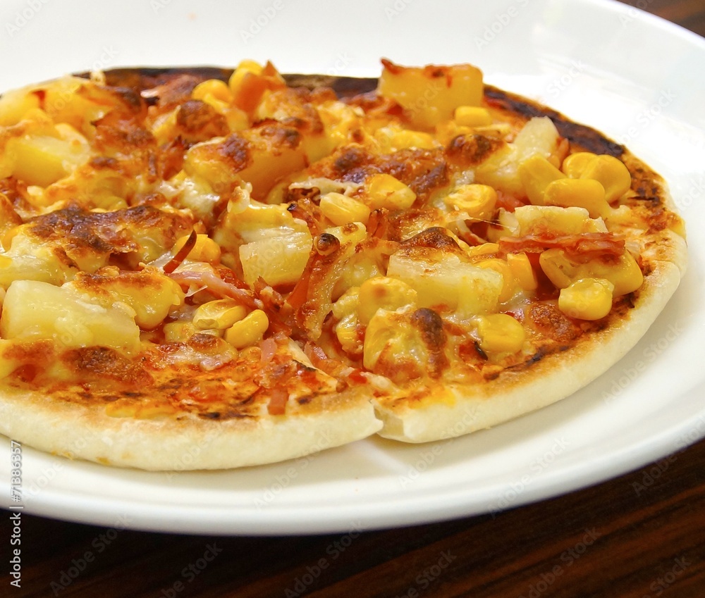 Delicious pizza closeup on a plate Delicious pizza closeup on a plate