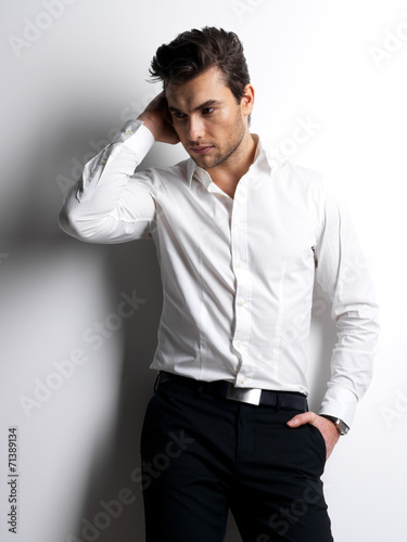 Fashion portrait of young man in white shirt