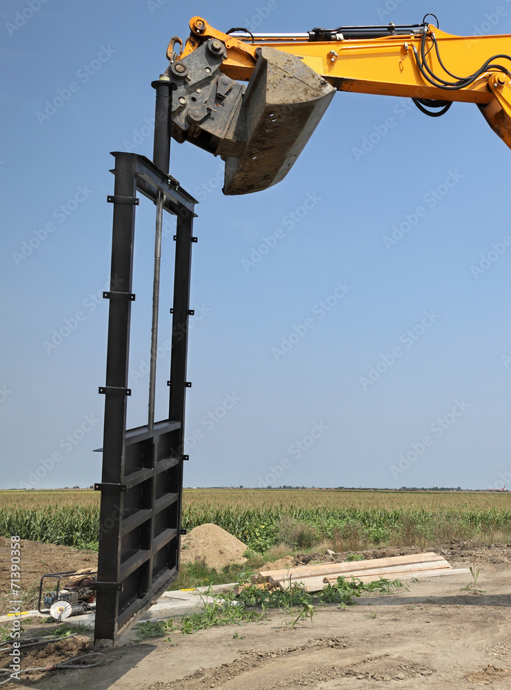 Agriculture, irrigation gate at channel construction site Agriculture, irrigation gate at channel construction site