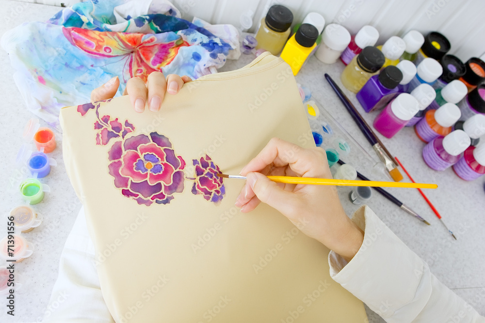 Fototapeta premium Batik process: artist paints on fabric, Batik painting