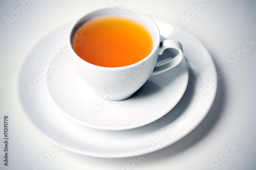 Herbal hot tea in ceramic cup on plate
