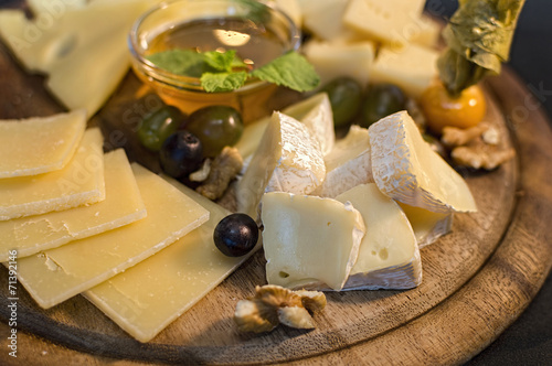 Wooden plate with cheese in assortment