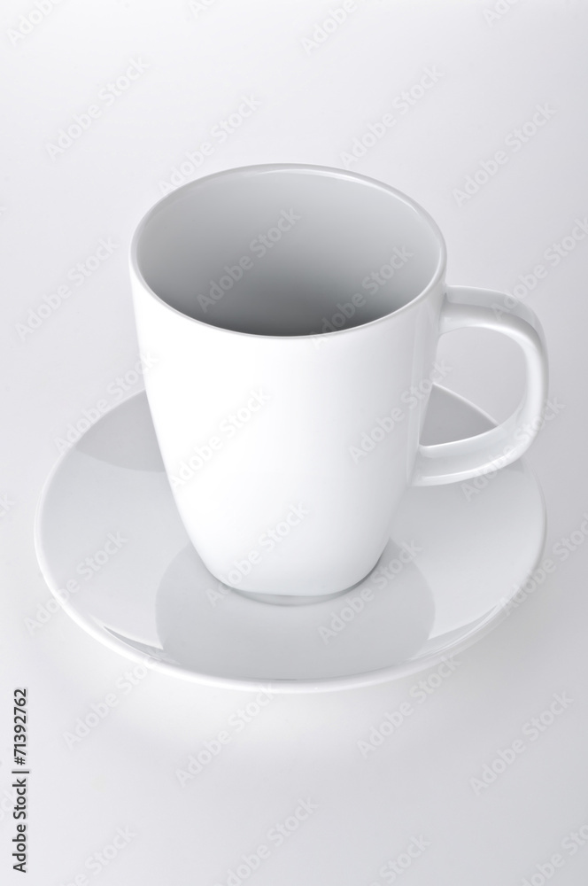 White cup with seucer isolated on gray background White cup with seucer isolated on gray background