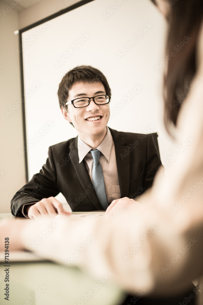 Successful young business executives meeting at the office Successful young business executives meeting at the office