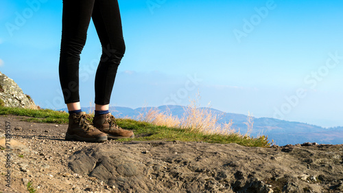 Unrecognizable female hiker on top of the mountain, Scotland © andreaobzerova