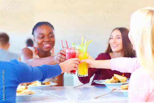 multiracial female friends having fun in restaurant