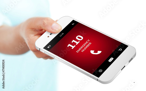 hand holding mobile phone with emergency number 110