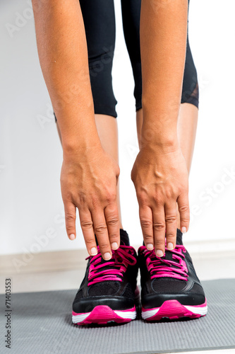 Woman leaning forwards to stretch