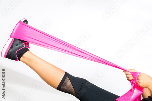 Woman stretches with resistance bands around her foot