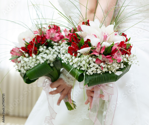 beautiful bridal bouquet of lilies and roses at a wedding party
