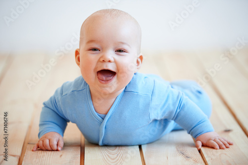 Konstfotografi Cute happy baby boy crawling on the floor