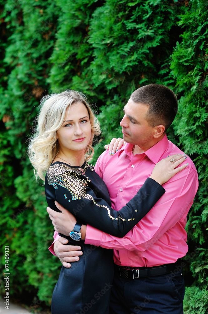 Fototapeta premium Cute young couple lying in a park